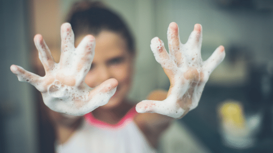 girl with outstretched soapy hands